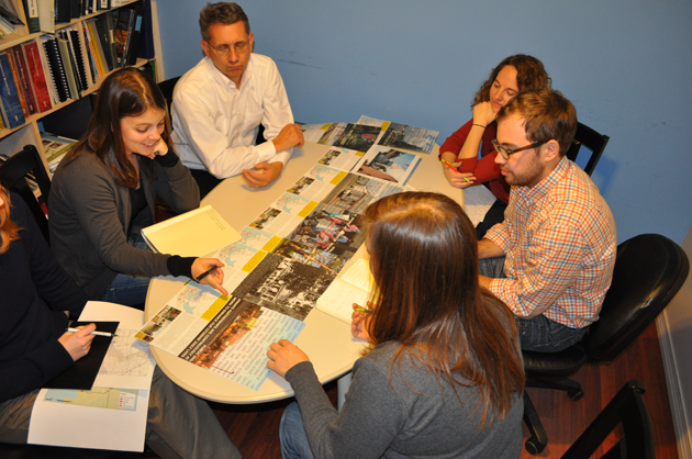 Interns discussing a project around a table.